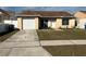 Cute one-story home with a brown roof, white garage door, and well-maintained lawn at 1915 Crown Park Dr, Valrico, FL 33594