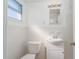 Clean bathroom with white vanity, toilet, and tiled walls at 2009 Windsor Way, Tampa, FL 33619
