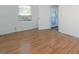 Bedroom featuring wood floors, window, and exterior access at 2009 Windsor Way, Tampa, FL 33619