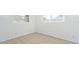 Empty bedroom with tile floors and two windows at 2009 Windsor Way, Tampa, FL 33619