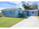 Newly painted light blue home with a spacious yard and driveway at 2009 Windsor Way, Tampa, FL 33619