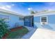 Newly painted light blue home with a spacious yard and driveway at 2009 Windsor Way, Tampa, FL 33619