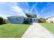 Newly painted light blue home with a spacious yard and driveway at 2009 Windsor Way, Tampa, FL 33619
