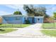 Newly painted light blue home with a spacious yard and driveway at 2009 Windsor Way, Tampa, FL 33619