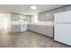 Modern kitchen with gray cabinets and white appliances at 2009 Windsor Way, Tampa, FL 33619
