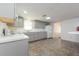 Bright kitchen features gray cabinets, tiled floor, and white appliances at 2009 Windsor Way, Tampa, FL 33619