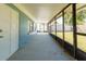 Screened-in porch with concrete floor and backyard access at 2009 Windsor Way, Tampa, FL 33619