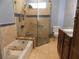 Modern bathroom featuring a glass shower, soaking tub, and dark wood vanity with a marble countertop at 2046 Winding Oaks Dr, Palm Harbor, FL 34683