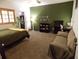 Cozy bedroom with plush carpet, a decorative bicycle on the wall, and ample natural light at 2046 Winding Oaks Dr, Palm Harbor, FL 34683