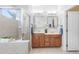 Bathroom boasts dual vanity, a shower, and soaking tub at 24745 Portofino Dr, Lutz, FL 33559