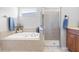 Large bathroom with a shower, garden tub, and double sinks at 24745 Portofino Dr, Lutz, FL 33559