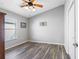 Spacious bedroom with wood-look flooring and a ceiling fan at 24745 Portofino Dr, Lutz, FL 33559
