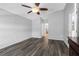 Bright and spacious bedroom with wood-look flooring and ceiling fan at 24745 Portofino Dr, Lutz, FL 33559