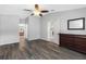 Bright bedroom featuring wood-look floors and a ceiling fan at 24745 Portofino Dr, Lutz, FL 33559