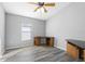 Bedroom with wood-look floors, corner desk and window at 24745 Portofino Dr, Lutz, FL 33559