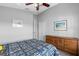 Bedroom with wood-look floors, a ceiling fan, and a dresser at 24745 Portofino Dr, Lutz, FL 33559