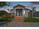 House exterior at dusk with ramp and front porch at 2515 N Howard Ave, Tampa, FL 33607