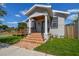 Updated bungalow features a front porch with columns and brick steps at 2515 N Howard Ave, Tampa, FL 33607