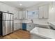 Modern kitchen boasts stainless steel appliances and teal dishwasher at 2515 N Howard Ave, Tampa, FL 33607