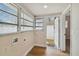 Bright laundry area with wood flooring and access to the backyard at 2515 N Howard Ave, Tampa, FL 33607
