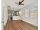 Bright living room features hardwood floors, an open concept layout, and a modern kitchen at 2515 N Howard Ave, Tampa, FL 33607