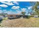 Large backyard with grassy area, screened patio, and storage shed at 2533 Duncan Dr, Belleair Bluffs, FL 33770