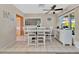 Bright dining area with a white table and chairs, and built-in storage at 2533 Duncan Dr, Belleair Bluffs, FL 33770