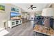 Open living room with hardwood floors, a couch, and view of dining area at 2533 Duncan Dr, Belleair Bluffs, FL 33770