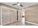 Bedroom with gray tile flooring, ceiling fan, closet and open door to living area at 2619 Miriam S St, Gulfport, FL 33711