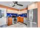 Modern kitchen featuring stainless steel appliances and bright blue backsplash tiles at 2619 Miriam S St, Gulfport, FL 33711