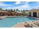 Relaxing pool area with shaded seating and lounge chairs at 2765 Via Cipriani # 1232B, Clearwater, FL 33764