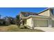 Two-story townhome with attached garage and landscaped front yard at 2933 Jacob Crossing Ln, Holiday, FL 34691