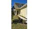 Townhome entry with walkway, landscaping, and dark brown door at 2933 Jacob Crossing Ln, Holiday, FL 34691