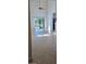 Bright living room with high ceilings, tile floors, and sliding glass doors leading to the backyard at 2933 Jacob Crossing Ln, Holiday, FL 34691