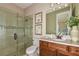 Elegant bathroom with glass shower and wood vanity at 29658 Cassino Ct, Wesley Chapel, FL 33543
