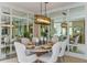 Bright dining room with large chandelier and mirrored wall at 29658 Cassino Ct, Wesley Chapel, FL 33543