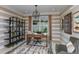 Spacious home office features built-in shelving and large window at 29658 Cassino Ct, Wesley Chapel, FL 33543
