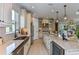 Open concept kitchen with stainless steel appliances and breakfast bar at 29658 Cassino Ct, Wesley Chapel, FL 33543
