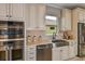 Modern kitchen with stainless steel appliances and farmhouse sink at 29658 Cassino Ct, Wesley Chapel, FL 33543