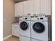 Convenient laundry room with washer, dryer, and storage cabinets at 29658 Cassino Ct, Wesley Chapel, FL 33543