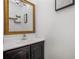 Small bathroom with dark vanity, white sink, and gold framed mirror at 3105 W Spruce St, Tampa, FL 33607