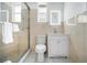 Clean bathroom with a shower, toilet and white vanity with a lighted mirror at 3105 W Spruce St, Tampa, FL 33607