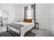 Cozy bedroom with metal bed frame, gray blanket, and an adjacent bathroom at 3105 W Spruce St, Tampa, FL 33607