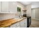 Updated kitchen with butcher block countertops and white cabinets at 3105 W Spruce St, Tampa, FL 33607
