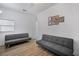 Living room with two gray couches, wood floors, and framed artwork at 3105 W Spruce St, Tampa, FL 33607