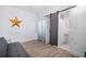 Living room with gray couch, barn door, and small bathroom at 3105 W Spruce St, Tampa, FL 33607