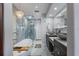 Luxurious bathroom with a soaking tub, walk-in shower, dual sinks, and elegant lighting fixtures at 380 Pinellas Bayway S. # E, Tierra Verde, FL 33715