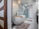 Modern bathroom featuring a freestanding tub, glass-enclosed shower, and elegant chandelier at 380 Pinellas Bayway S. # E, Tierra Verde, FL 33715