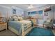 Cozy bedroom with a four-poster bed, soft blue hues, and ample natural light from the window at 380 Pinellas Bayway S. # E, Tierra Verde, FL 33715