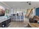 Open concept featuring a stylish kitchen with bar stool seating and a view of the living area at 380 Pinellas Bayway S. # E, Tierra Verde, FL 33715